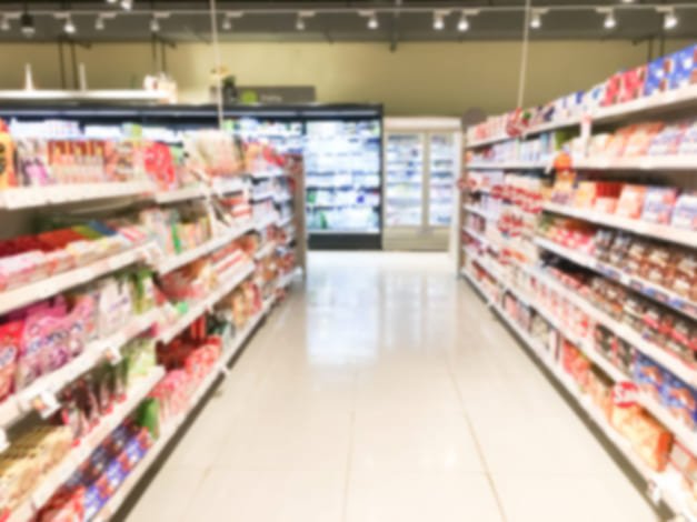Imagem borrada de prateleiras em supermercado representando rotulagem nutricional